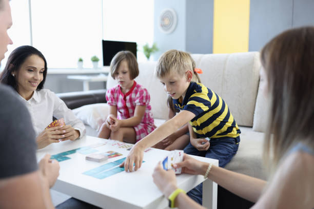 istock Parents and children play board game together at table 1421657551