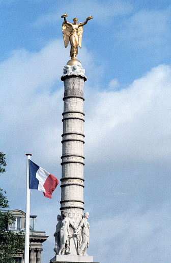 Paris, France - 1983: A vintage 1980's Fujifilm negative film scan of the Place de la Bastille July Column where the Bastille prison stood until the storming of the French Revolution.