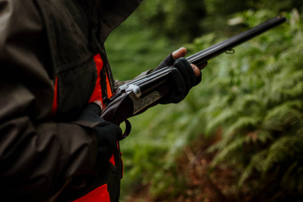 istock photo of hunter holding rifle 1421659472