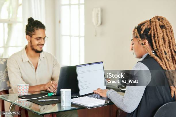 Smiling Young Colleagues Working On Laptops In Their Startups Home Office Stock Photo - Download Image Now