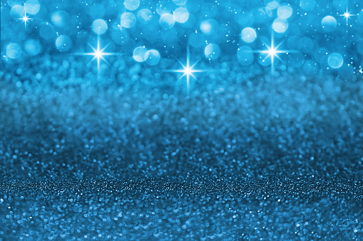 Blue defocused shiny with stars and glitter, shimmer and sparkle background. Christmas, New Year. Copy space