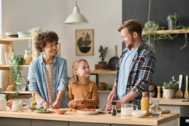 istock Family with child cooking dinner 1421662264