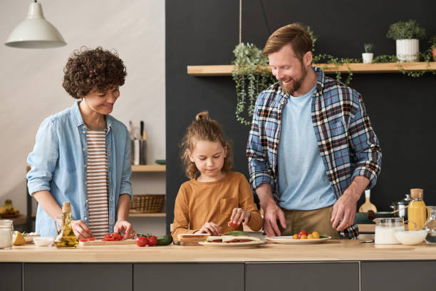 istock Little boy helping his parents to cook 1421662280