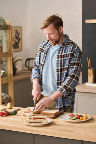 istock Man preparing sandwiches for breakfast 1421662304