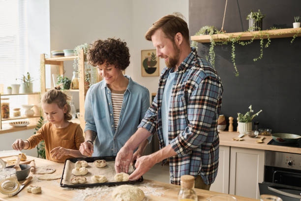 istock Family preparing homemade buns together 1421662347