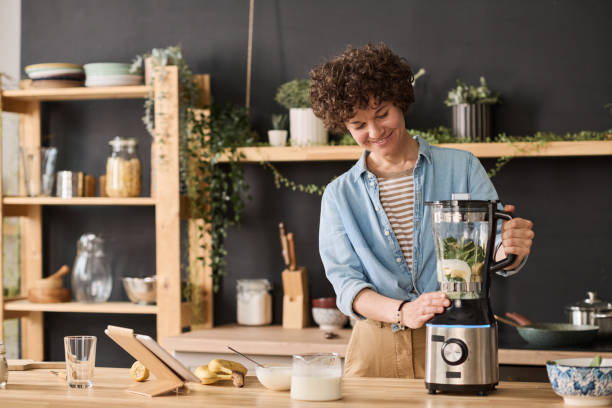 istock Woman making fresh smoothie in blender 1421662955