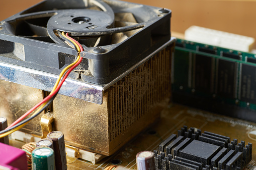 A thick layer of dust covers the internal electronic components of the computer.