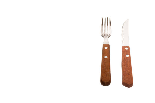 istock A knife and a fork with a wooden handle isolated on a white background with space for text 1421666072