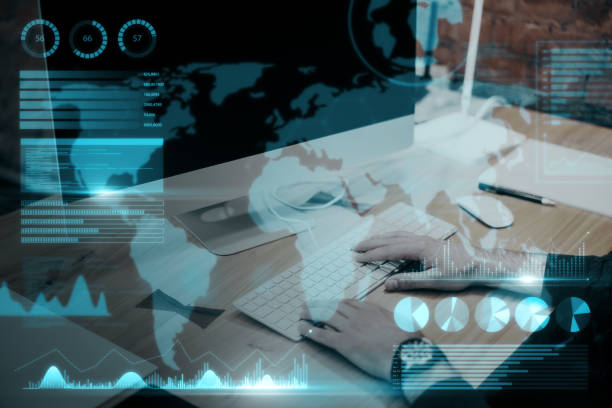 istock Close up of businessman hand using computer keyboard at desktop with abstract map and business chart hologram on blurry background. Investor, finance and financial dashboard concept. Double exposure. 1421666856