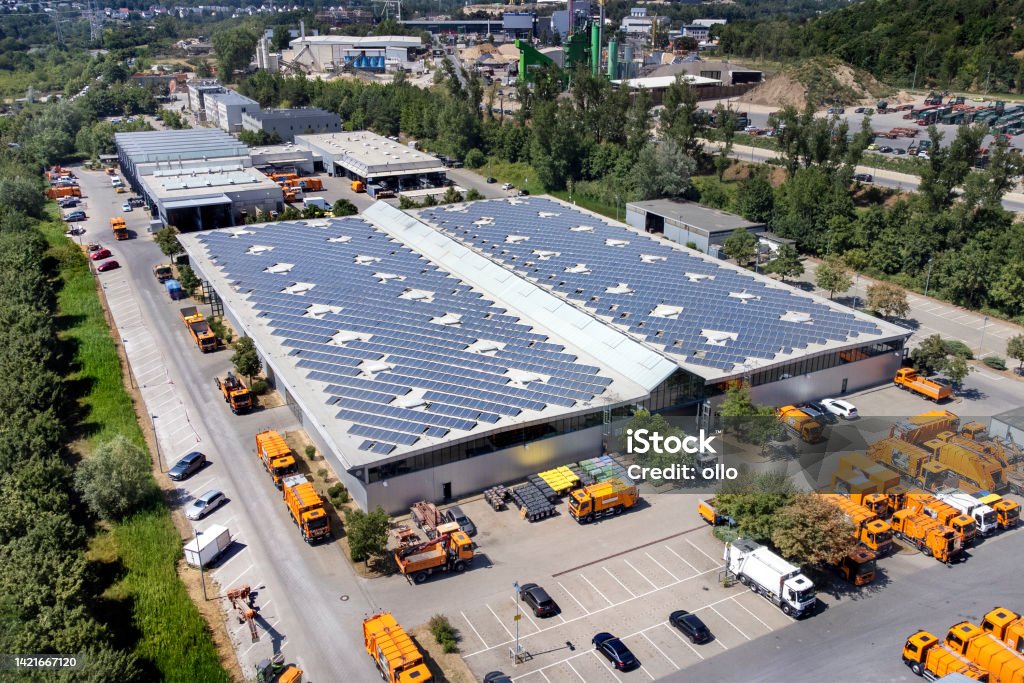 Large industrial building, solar panels and trucks - aerial view Freight Transportation Stock Photo