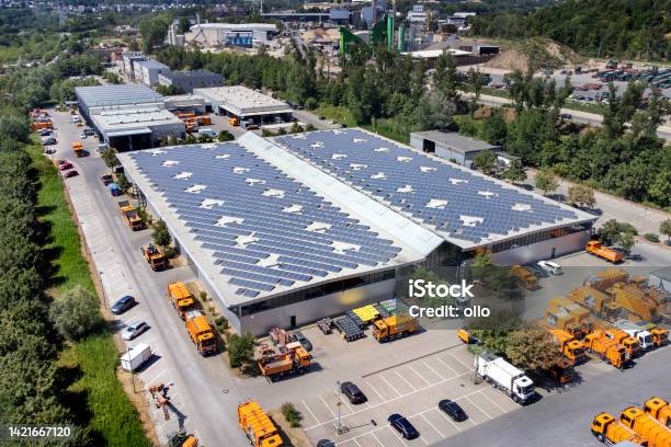 Large Industrial Building Solar Panels And Trucks Aerial View Stock Photo - Download Image Now
