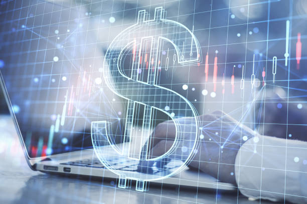istock Close up of hands using laptop with creative glowing dollar hologram and forex chart on blurry background. Money, trade, market, online banking app, currency and finance concept. Double exposure. 1421667746