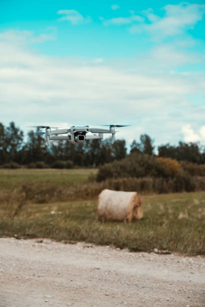 istock Drone With Camera Rose Over Rural Road, Next To Haystack. 1421669020