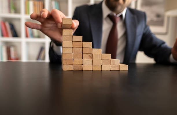 istock Businessman Stop Domino Effect. Risk Management and Insurance Concept 1421669607