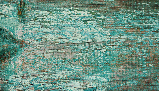Old wooden turquoise color background. Vintage grunge fence from wood deck