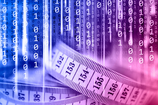 Close-up of a tape measure on a binary code background. Can illustrate the concepts of online fitness class, online training lessons, online workout, online fitness program, online coach, etc.