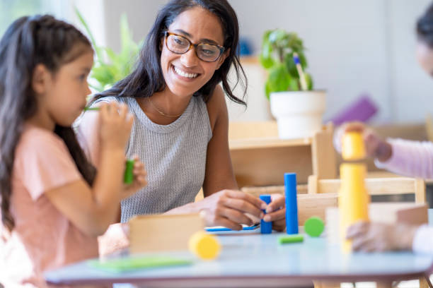 istock Montessori Teacher with Students 1421675496