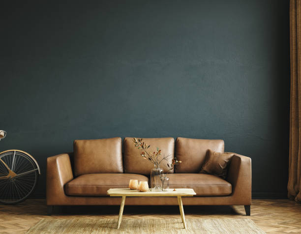 Home interior mock-up with brown leather sofa, table and decor in living room stock photo