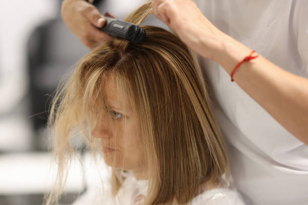 istock Pulling strands of hair with professional iron care 1421675859