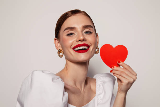 istock Beautiful emotional woman holding present box 1421681773