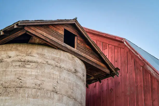 detail of old, weathered, red barn against dusk sky at Colorado foothills