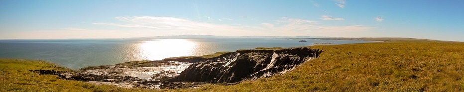 Slump in cliff caused by melting permafrost on Herschel Island, Yukon Territory, Canada along Mackenzie Bay.,