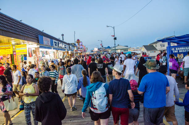 Crowd walking on Wildwood boardwalk at night