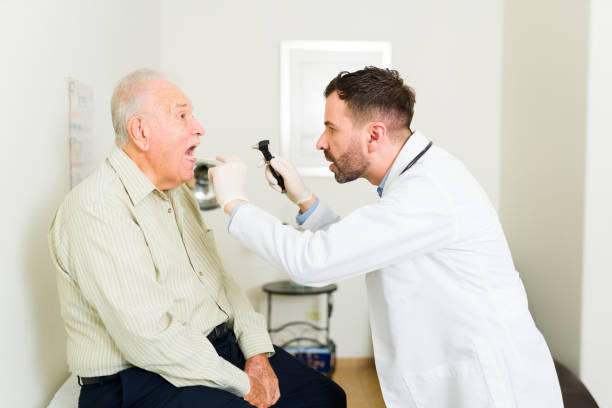 istock Professional doctor doing a medical check up on an elder patient 1421686629