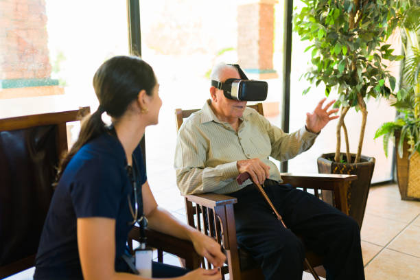istock Elderly man having fun with virtual reality technology at the retirement home 1421688088