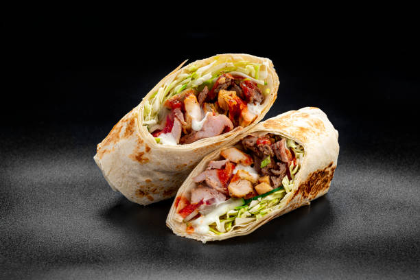 istock Beef shawarma on a dark background. Shawarma with beef in pita bread 1421688507