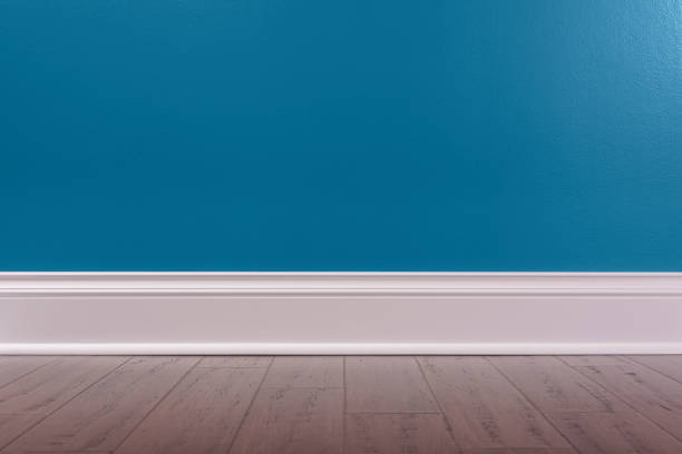Empty room background with a blue wall, white baseboard and rustic wooden floor An Empty room background with a dark blue wall, white baseboard and rustic wooden floor. floorboard stock pictures, royalty-free photos & images