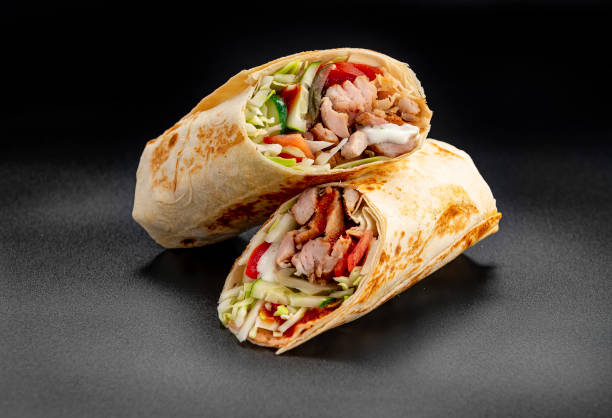 istock Beef shawarma on a dark background. Shawarma with beef in pita bread 1421688533