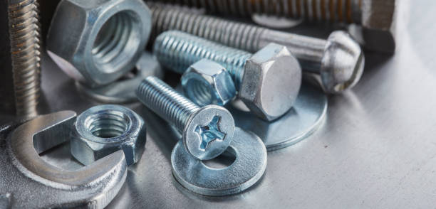 istock set of different nuts, bolts, screws, washers and drill bits,thread tap and mill cutters on steel plate background. Locksmithing deal. 1421693356