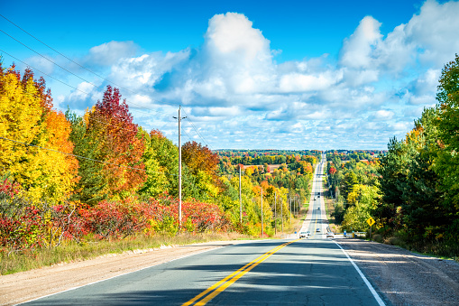 Highway leading through autumn landscape near Barrie, Ontario, Canada.