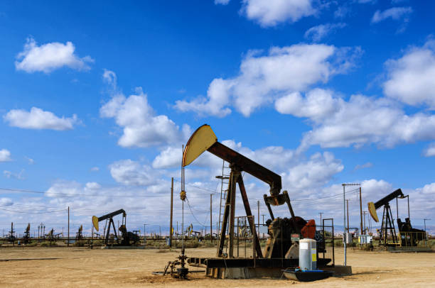 istock Oil Pumpjacks with Clouds in Background 1421697351