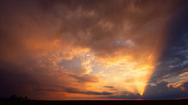 istock Bright sunset, with orange sun rays. Landscape. 1421697874