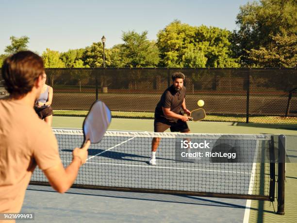 Young Adults Playing Pickleball On A Public Court Stock Photo - Download Image Now - Pickleball, Paddle Tennis, Teamwork