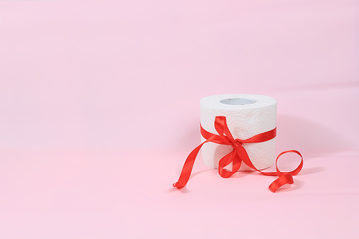Toilet paper rolls as a Christmas or birthday present, used as a hygiene product in washrooms, a very scarce commodity in the energy crisis in Europe, selective focus