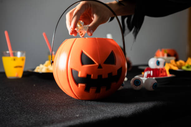 istock Halloween party decoration. Pumpkin shaped popcorn container 1421700442