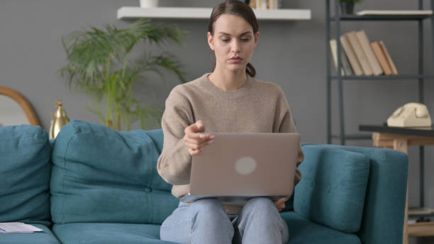 istock Woman Closing Laptop, Leaving Sofa 1421701436