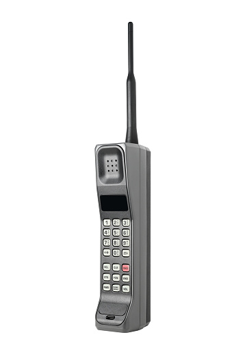 Front angle view of a classic mobile cell phone from the 1980s and early 1990s, isolated on white background.