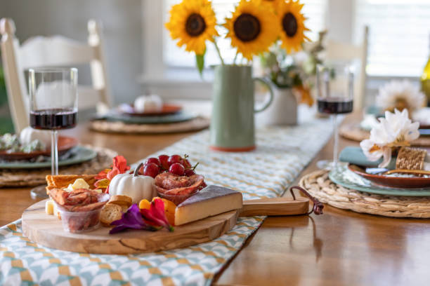 istock Fall dining table with charcuterie board in the foreground 1421713028