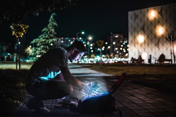istock Caucasian guy opening a backpack in the park 1421713088