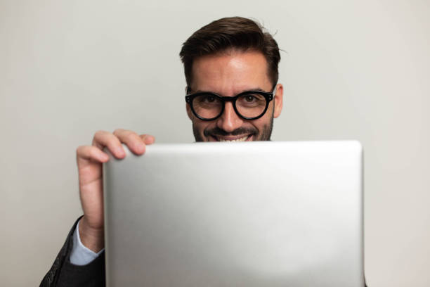 istock Businessman with laptop. Studio portrait 1421714571