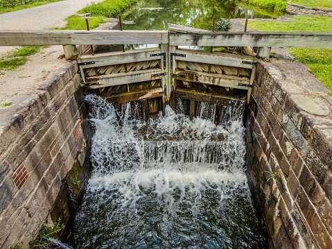 Potomac, MD, USA - August 19, 2022: Image is of Canal Lock 19 of the C&O canal in Potomac, MD. The image is  taken from the bridge beside the canal.