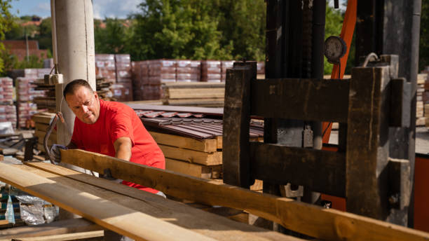 istock One man choose wood plank at warehouse or construction site 1421720147