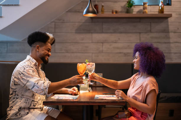 istock Young couple toasting at romantic dinner 1421721043