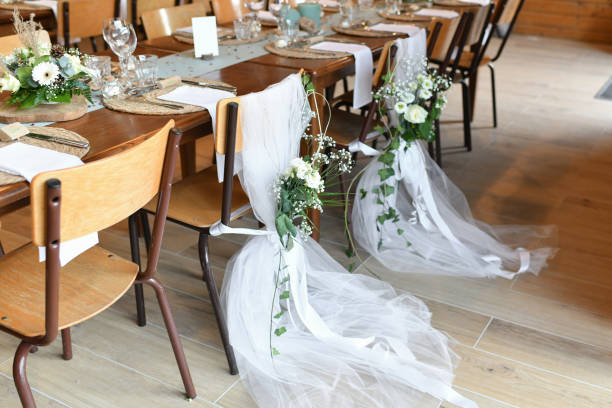 istock Wedding chairs decorated with white tulle and flowers 1421723134