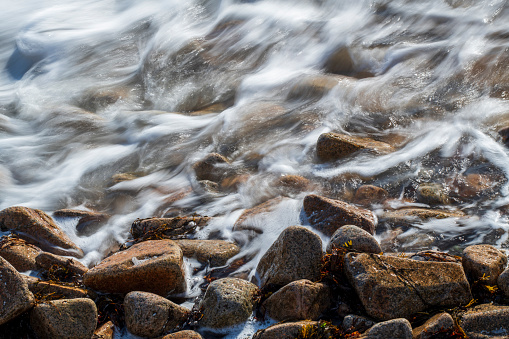 Waves running over rocks at Schoodic Peninsula, Acadia National Park, Maine, USA