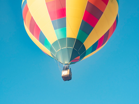 Looking up at a colourful hot air balloon